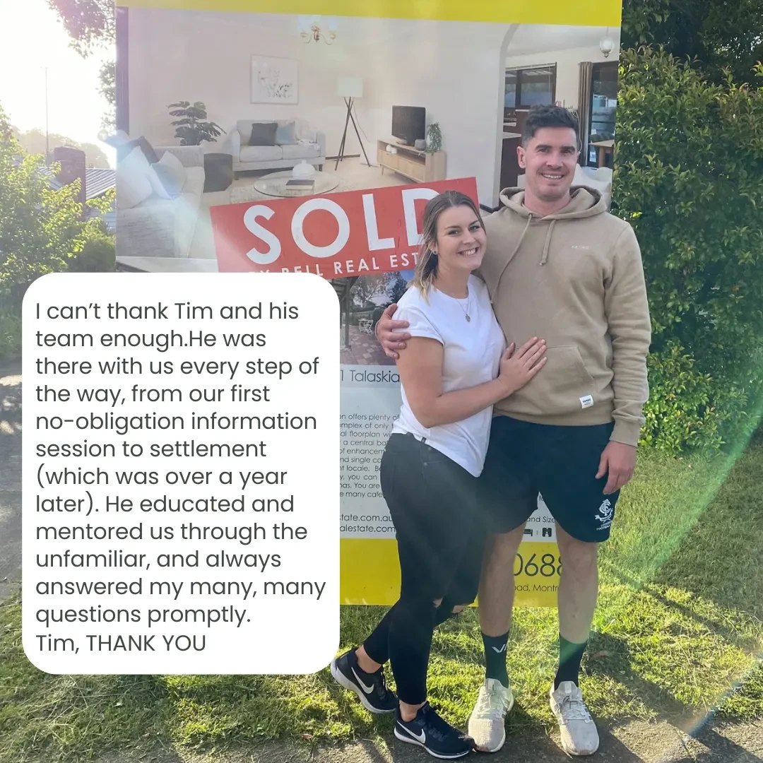 A couple in front of their sold home thanking Tim and the Finance 4 Nurses team